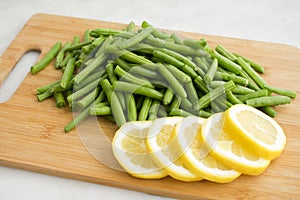 Green Beans and Lemon Slices on a Cutting Board