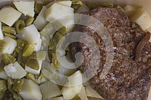 Green beans and potato dices with burger