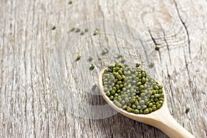 Green beans in spoon on wooden floor, Cereal on wooden floor