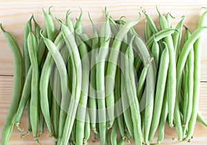 Green beans on wooden background