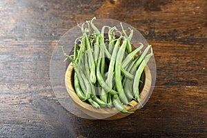 Green beans on wooden background