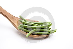 Green beans on wooden spoon
