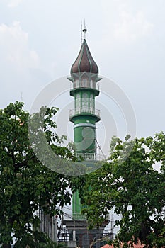 Green beautiful minarate of the mosque