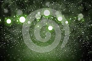 Green beautiful sparkling glitter lights defocused bokeh abstract background with sparks fly, festal mockup texture with blank