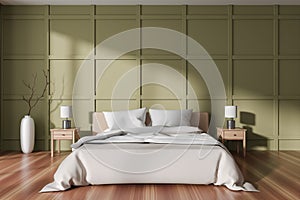 Green bedroom interior with bed and decor on nightstand. Empty wall