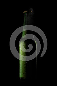 Green beer bottle with drops