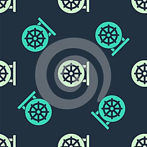 Green and beige Dharma wheel icon isolated seamless pattern on blue background. Buddhism religion sign. Dharmachakra