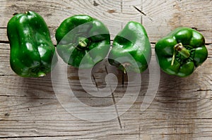 Green bell pepper on wooden background