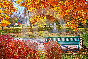 Green bench in autumn park