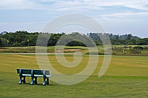 Green bench in front of golf course, Barra da Tijuca photo