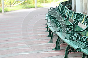 Green benches in the public park equipment furniture of decorate