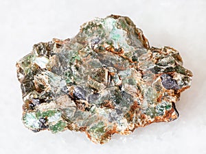 green beryl crystals in rough rock on white