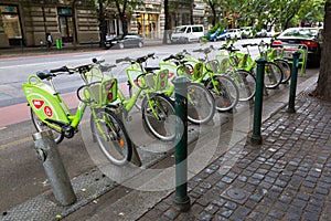 Green bicycles from MOL BuBi docking by street in Budapest, Hungary. It is a bicycle sharing network in Hungary