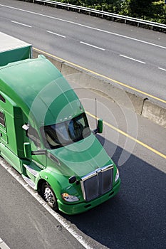 Green big rig semi truck for long haul cargo transporting dry va photo