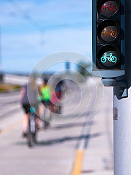 Green Bike traffic lights and riding cyclists photo