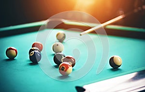On a green billiard table are balls, and a man with a cue in his hands, aims at one of the balls