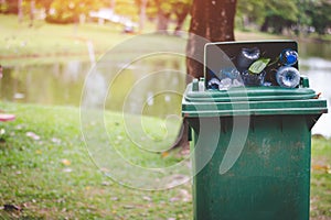 The green bin is full of rubbish.