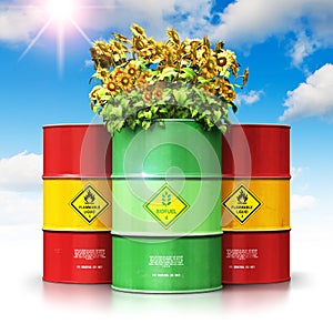 Green biofuel drum with sunflowers in front of red oil or gas ba