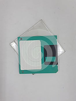 Green And Black Floopy Disk On White Background