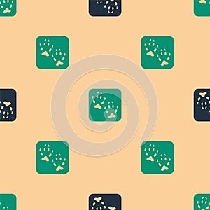 Green and black Fox paw footprint icon isolated seamless pattern on beige background. Vector
