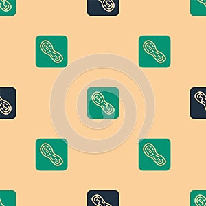 Green and black Human footprints shoes icon isolated seamless pattern on beige background. Shoes sole. Vector