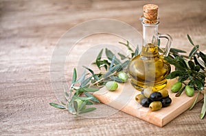 Green and black olives with olives branch and bottle of olive oi