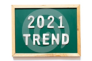 Green blackboard and wood frame with word 2021 trend on white background