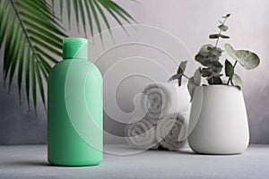Green blank packaging cosmetic bottle with palm leaves