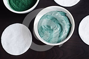 Green blue bentonite clay and yogurt mask in the bowl. Diy facial mask and body wrap recipe. Close up, top view