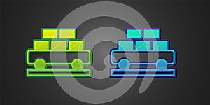 Green and blue Cargo train wagon icon isolated on black background. Full freight car. Railroad transportation. Vector