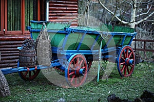 A green and blue carriage with red and blue wheels