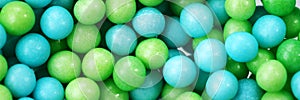 Green and blue eatable sugar pearls for food decoration. Panorama