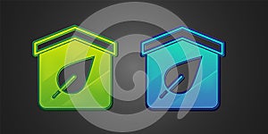 Green and blue Eco friendly house icon isolated on black background. Eco house with leaf. Vector