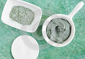 Green blue, grey bentonite clay in a bowl. Clay texture close up. Diy mask and body wrap recipe. Natural beauty treatment