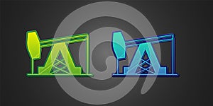 Green and blue Oil pump or pump jack icon isolated on black background. Oil rig. Vector