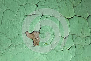 Green blue old shabby wall with damages and cracks. rough surface texture