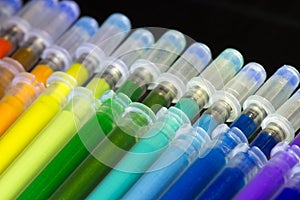 Green, blue and other refills of a colored pens close-up. Set school office supplies. Colorful ink cartridges