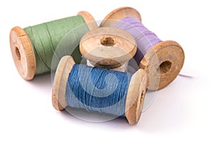 green blue purple white sewing thread on white background isolated