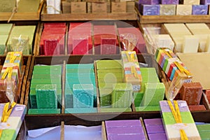 Green blue purple yellow and red soap at a farmer market in France, Europe. Italian hand made soap. Street French market at Nice.