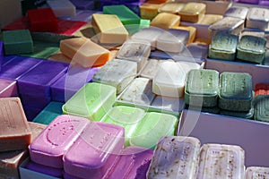 Green blue purple yellow and red soap at a farmer market in France, Europe. Italian hand made soap. Street French market at Nice.