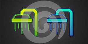 Green and blue Shower head with water drops flowing icon isolated on black background. Vector