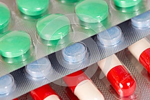 Green, blue and white-and-red antibiotic capsules