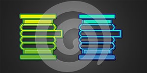 Green and blue Wire electric cable on a reel or drum icon isolated on black background. Vector