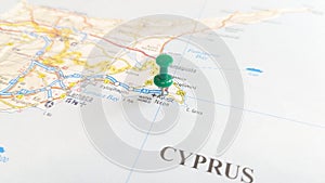 A green board pin stuck in Ayia Napa on a map of Cyprus