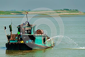 Green boat on Irrawaddy river