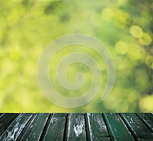 Green Bokeh Background with Empty Wooden Board