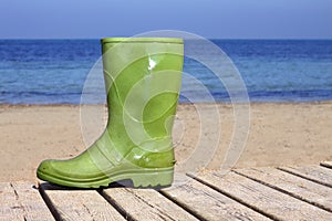 Green boot on beach unlucky fisherman metaphor photo