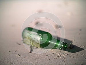 Green bottle lying on a Seychelles beach