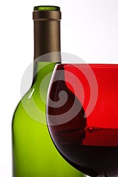 Green bottle, red wine glass