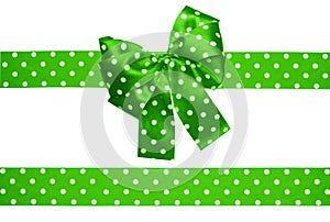 Green bow and ribbon with white polka dots made from silk